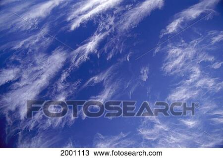 Stock Image - Blue Sky With Wispy White Clouds High In Atmosphere. Fotosearch