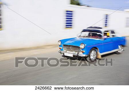 Stock Image - Blue taxi on the street in the old city of Harar in Eastern Ethiopia; Harar, Ethiopia. Fotosearch
