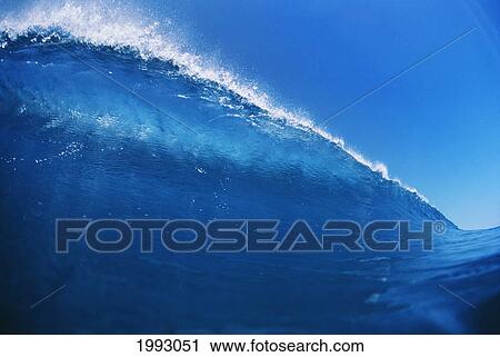 Stock Image - Blue Wave At It's Peak With White Wash, Blue Sky.. Fotosearch