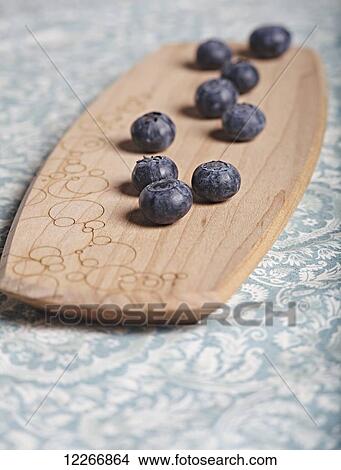Blueberries on wooden cutting board; Ontario, Canada View Large Photo Image Picture - Blueberries on wooden cutting board; Ontario, Canada. Fotosearch