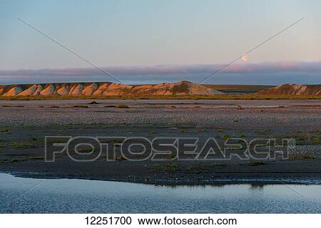 Stock Image - Bluff bank in the warm sunset light; Deadhorse, Alaska, United States of America. Fotosearch