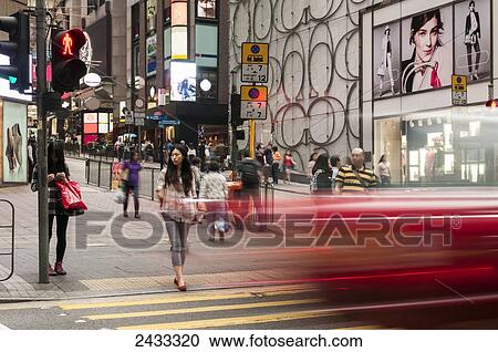 Blur of a vehicle on a road as a pedestrian waits to cross; Hong Kong, China View Large Photo Image Stock Image - Blur of a vehicle on a road as a pedestrian waits to cross; Hong Kong, China. Fotosearch