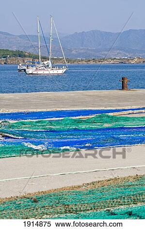 Stock Photography - Boat And Nets In Port De La Selva. Fotosearch