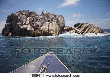 Stock Image - Boat And Rocks Off Cousine Island. Fotosearch