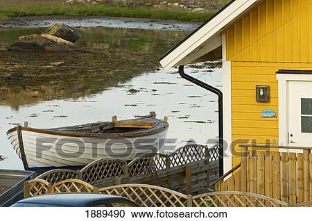 Stock Image - Boat And Traditional House On Flaton Island.. Fotosearch