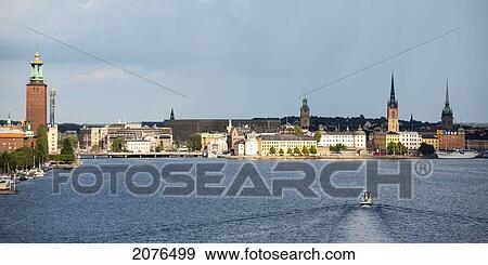 Boat In The Water And Buildings Along The Water's Edge; Stockholm Sweden View Large Photo Image Stock Photo - Boat In The Water And Buildings Along The Water's Edge; Stockholm Sweden. Fotosearch