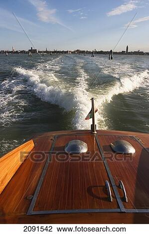 Stock Image - Boat Leaving Venice, Italy.. Fotosearch