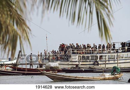 Stock Photo - Boat-Load Of Tourists Arriving. Fotosearch