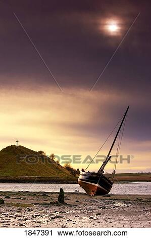 Stock Image - Boat On Beach At Low Tide; Alnmouth, Northumberland, England. Fotosearch