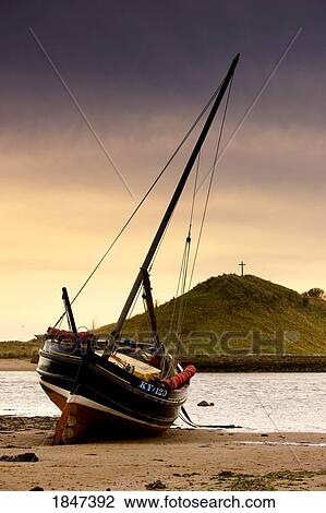 Stock Image - Boat On Beach At Low Tide; Alnmouth, Northumberland, England. Fotosearch