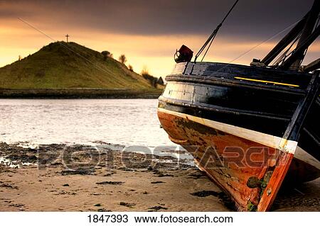 Stock Image - Boat On Beach At Low Tide; Alnmouth, Northumberland, England. Fotosearch