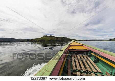 Stock Photo - Boat on Lake Sentani, Papua, Indonesia. Fotosearch
