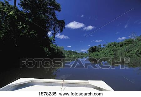 Stock Photography - Boat On Rio Tributary Of Amazon. Fotosearch