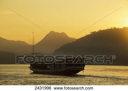 Boat on the Mekong River at sunset; Luang Prabang, Laos View Large Photo Image Stock Photograph - Boat on the Mekong River at sunset; Luang Prabang, Laos. Fotosearch