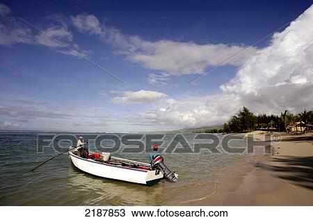 Stock Image - Boat sitting by the shore, Shanti Ananda Maurice Hotel and Spa; Mauritius. Fotosearch