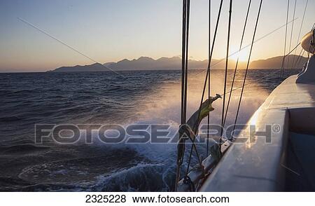 Boat splashing through water along Lycian coast at sunset; Turkey View Large Photo Image Stock Photo - Boat splashing through water along Lycian coast at sunset; Turkey. Fotosearch