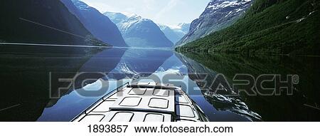 Stock Photo - Boat Traveling Through Lavtn Lake. Fotosearch