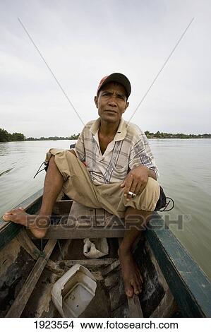 Picture - Boatman Taking Travelers Out On Mekong River In Si Phan Don Area, Laos. Fotosearch
