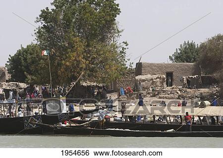 Stock Photograph - Boats along a village along the Niger River between Niafunke and Kabara, Mali. Fotosearch