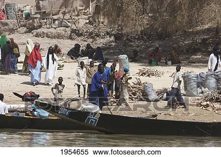 Stock Photography - Boats along a village along the Niger River between Niafunke and Kabara, Mali. Fotosearch
