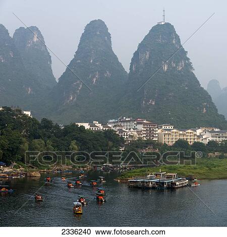 Boats Along The Li River And Peaked Mountains; Guilin, Guangxi, China View Large Photo Image Stock Image - Boats Along The Li River And Peaked Mountains; Guilin, Guangxi, China. Fotosearch