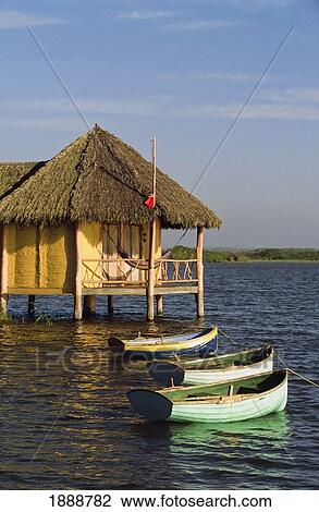 Stock Image - Boats And Room On Stilts. Fotosearch