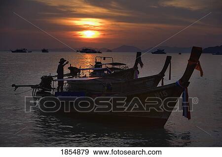 Stock Photo - Boats At Sunset, Krabi, Thailand. Fotosearch