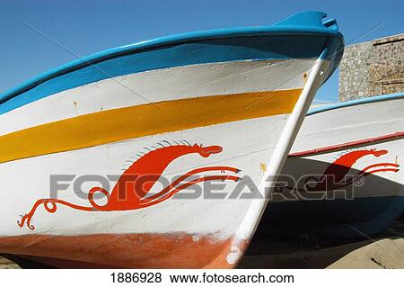 Stock Photo - Boats Decorated With Traditional Sea-Horse Motifs On The Small Beach In The Harbor. Fotosearch