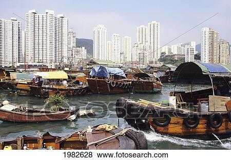 Stock Photo - Boats in a harbour with skyscrapers along the coast. Fotosearch