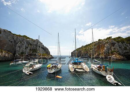 Stock Photo - Boats In Cales Coves, Menorca, Balearic Islands, Spain. Fotosearch