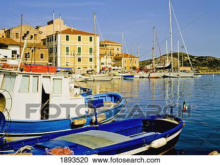 Stock Image - Boats In Port Of La Maddalena. Fotosearch
