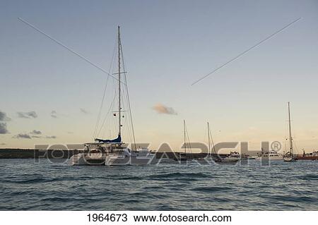 Stock Image - Boats In Puerto Ayora Harbor Off Santa Cruz Island At Dusk; Galapagos Equador. Fotosearch