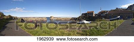 Boats In The Harbor In A Fishing Village; Craster, Northumberland, England View Large Photo Image Stock Photo - Boats In The Harbor In A Fishing Village; Craster, Northumberland, England. Fotosearch