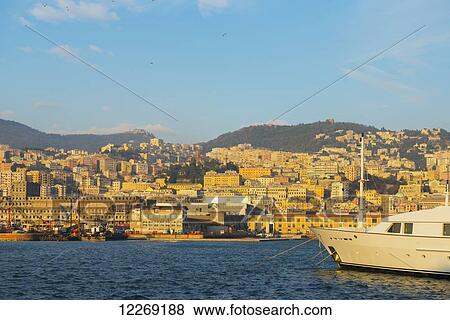 Stock Photo - Boats in the harbour and buildings on the waterfront; Genoa, Liguria, Italy. Fotosearch