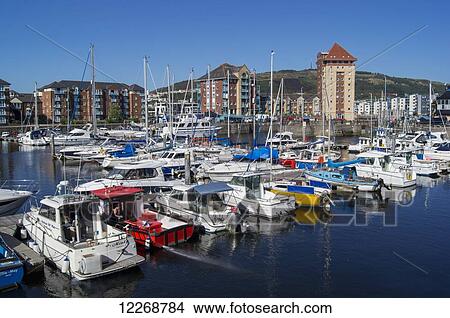 Picture - Boats in the marina and residential buildings at the waterfront; Swansea, Wales. Fotosearch