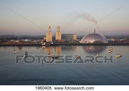 Stock Photography - Boats In The Water And An Industrial Area At The Water's Edge; Southampton, England. Fotosearch