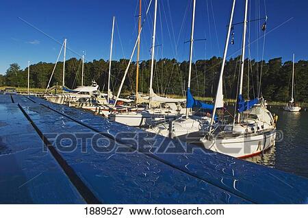 Boats Lined Up Along The Pier. View Large Photo Image Stock Photo - Boats Lined Up Along The Pier.. Fotosearch