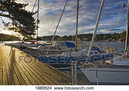 Boats Lining Up Along The Pier In Marina. View Large Photo Image Picture - Boats Lining Up Along The Pier In Marina.. Fotosearch