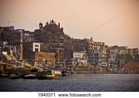 Boats Moored Along The Ganges River At Sunset; Varanasi India View Large Photo Image Stock Image - Boats Moored Along The Ganges River At Sunset; Varanasi India. Fotosearch