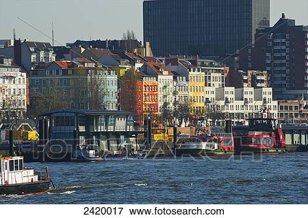 Boats moored along the river and colourful buildings; Hamburg Germany View Large Photo Image Stock Photo - Boats moored along the river and colourful buildings; Hamburg Germany. Fotosearch