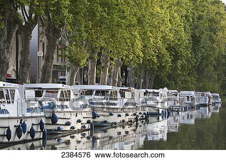 Boats moored along the shoreline of the Canal du Midi; France View Large Photo Image Stock Photograph - Boats moored along the shoreline of the Canal du Midi; France. Fotosearch