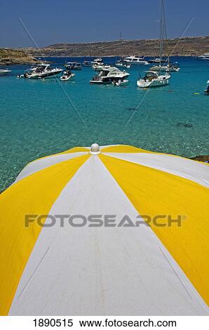 Stock Photography - Boats Moored At Blue Lagoon, Sun Umbrella In Foreground. Fotosearch