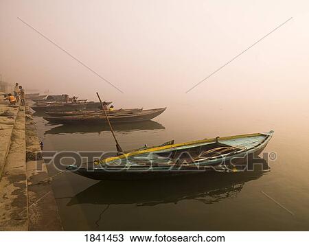 Stock Image - Boats Moored At Dawn; Varanasi, India. Fotosearch