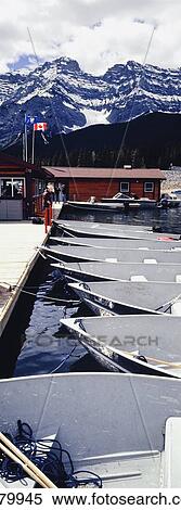 Stock Photography - Boats Moored At Lake Minnewanka.. Fotosearch