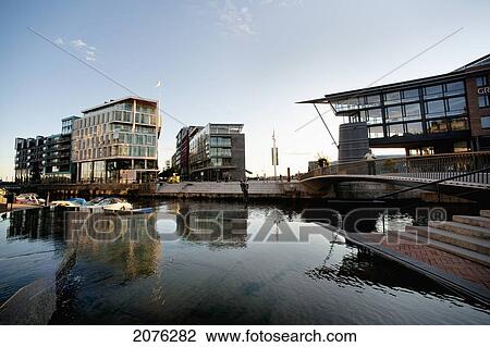 Stock Image - Boats Moored In A Canal With Residential Buildings; Oslo Norway. Fotosearch