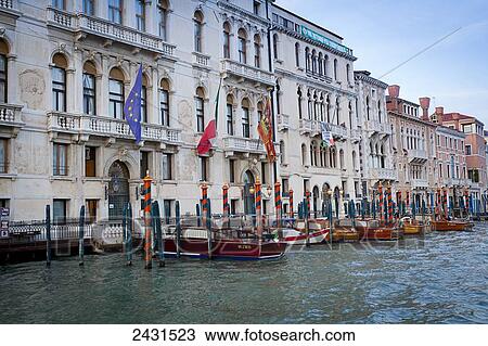 Stock Image - Boats moored in a row in a canal; Venice, Italy. Fotosearch