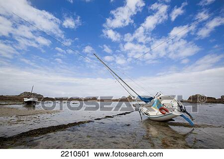 Stock Image - Boats moored on the North Brittany coast near Plougrescant on th Cotes D'Armor, France. Fotosearch