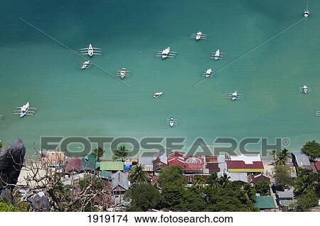 Boats Off Shore Of Tropical Island; El Nido, Palawan, Philippines View Large Photo Image Picture - Boats Off Shore Of Tropical Island; El Nido, Palawan, Philippines. Fotosearch