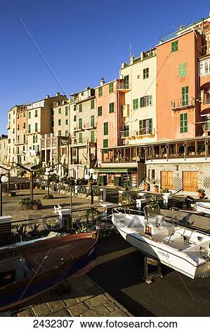 Boats on display on the shore with buildings at sunrise; Porto Venere, Liguria, Italy View Large Photo Image Stock Photo - Boats on display on the shore with buildings at sunrise; Porto Venere, Liguria, Italy. Fotosearch