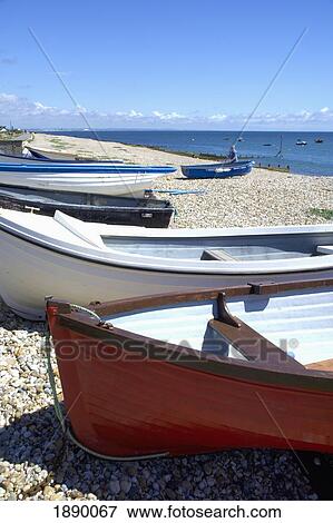 Stock Photo - Boats On Pebble Beach. Fotosearch